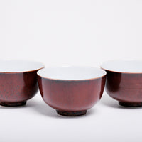Three vintage mahogany brown Japanese tea cups made of extra-light Arita porcelain, rich brown glaze and subtly speckled in black.