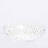 Side view of a heavy vintage Japanese glass bowl, shaped as a shell, showcasing the grooved form of its sides and zigzag rim. Available at NiMi Projects UK