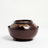 Side view of a vintage Japanese lacquerware lidded bowl, with deep red lacquer and gold gilt, hand-painted peonies and leaves on the lid. Available at NiMi Projects UK.