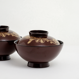 Two vintage Japanese lacuerware bowls, showing gilt gold, hand-painted design of chrysanthemums across the lids. On show at NiMi Projects UK.s