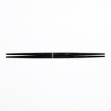 A pair of black Style of Japan ryokuchi double-end tapered wooden chopsticks(hashi)  on a white background. Available at NiMi Projects UK.