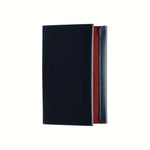 A top view of a Postalco Card Holder with a navy blue soft cow-hide cover and red cotton textile inner.