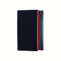 A top view of a Postalco Card Holder with a navy blue soft cow-hide cover and red cotton textile inner.