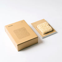 The Sankaku Vol. 02: Ramen limited edition book featuring vacuum-packed noodles as part of its cover. To its left is the limited edition box printed with an illustration of noodles drawn by Stanely Sun.