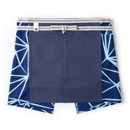 A modern interpretation of a short maekake Japanese apron in blue, featuring side panels with a white "crystal" pattern of lines, and a grey and white waist belt.