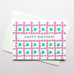 Takako Copeland’s letterpress-printed Birthday Card featuring a textile-like pattern of purple diamond bordered squares, each with green circle inside. Central to the design are the words “Happy Birthday” in gold.