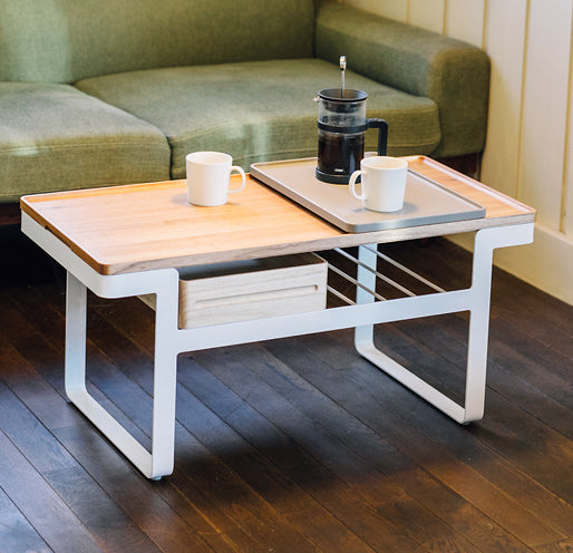 Atelier Yocto's modular Tray Table is a versatile coffee table, with a removable wooden tabletop on which Atelier Yocto serving trays slot perfectly. Available at NiMi Projects, UK.