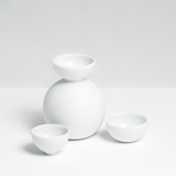 Ceramic Japan's white, matt porcelain Snowman Sake bottle and two small hemisphere cups, designed by Kaichiro Yamada, made in Seto, Japan, and sold at NiMi Projects UK