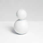 The Snowman Sake set, designed by Kaichiro Yamada for Ceramic Japan, is made of white porcelain and features a rotund bottle with two hemisphere sake cups that fit on top to create the snowman's head. Made in Seto, and photographed at NiMi Projects UK