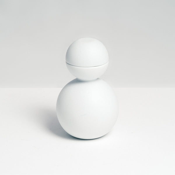 The Snowman Sake set, designed by Kaichiro Yamada for Ceramic Japan, is made of white porcelain and features a rotund bottle with two hemisphere sake cups that fit on top to create the snowman's head. Made in Seto, and photographed at NiMi Projects UK