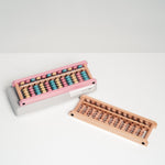 Soroban wooden abacus with pastel beads and natural wood beads, made in Japan by Daiichi. Available at NiMi Projects, UK.