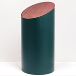 A cylindrical Moheim swing bin with a slanted, flat walnut wood lid, Japanese design, made in Japan and available at NiMi Projects UK.