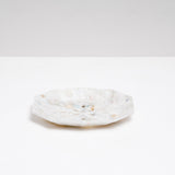 A side view of a Buoy recycled plastic polygon-shaped soap dish in mottled white, made of marine waste plastic collected from the shores of Japan.Edit alt text