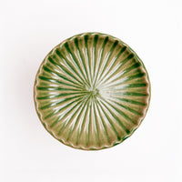 Top view of a forest green Japanese Mino-yaki porcelain fluted Hana Akari chrysanthemum dish, available at NiMi Projects UK.