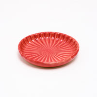 A side view of a small Hana Akari Japanese porcelain chrysanthemum plate, available at NiMi Projects UK.