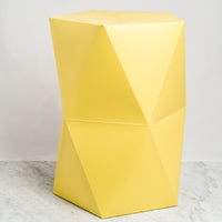 A Catachi yellow origami inspired polygonal stool, constructed in card and paper, and designed and made in Japan. Photographed by NiMi Projects UK.
