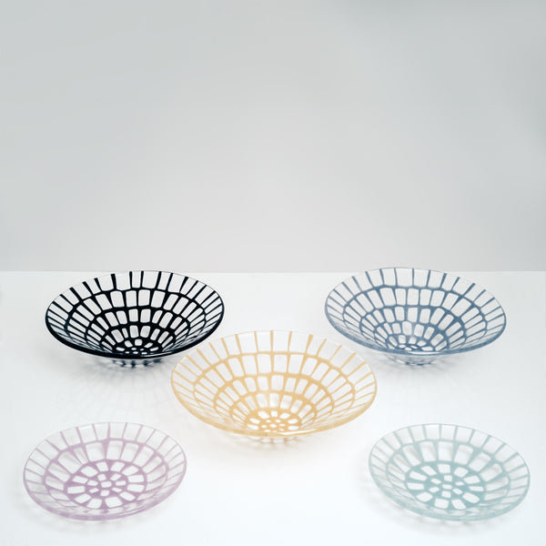 A collection of five Saburo Afumi artisanal glassware pieces — three large conical bowls and two small dishes, all made in Japan. Each is transparent with a windowed pattern in a vibrant colour — Navy blue, yellow and cornflower blue for the fruit bowls, pink and mint blue for the dishes.