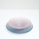A round blue-purple Shari Shari glass platter paired with a pink Shari Shari conical fruit bowl, both featuring tiny bubbles trapped in the glass for a frosty effect, hand crafted by artisan Saburo in Japan and available at NiMi Projects UK.