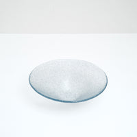 A Shari Shari conical glass fruit bowl in a bluish purple, hand crafted in Japan by Saburo. The glass features tiny bubbles giving it a semi-opaque frosted effect. Available at NiMi Projects UK.