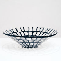 Hand crafted glass Saburo Afumi conical fruit bowl in profile, transparent with a grid pattern in deep navy blue, made in Japan and photographed by NiMi Projects UK.