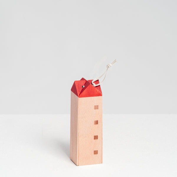 Special-edition SunaoLab wooden house trivet with pattern of four windows, a red roof and white hanging cord, made in Japan and available at NiMi Projects UK.