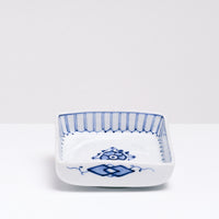 A NiMi Projects vintage Japanese blue and white porcelain square dish featuring sometsuke blue flower design and decorative striped details on the inside rim.