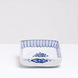 A NiMi Projects vintage Japanese blue and white porcelain square dish featuring sometsuke blue flower design and decorative striped details on the inside rim.
