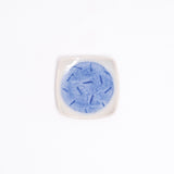 A NiMi Projects UK vintage square Japanese porcelain small dish in white, featuring a blue glaze central circle design with a pattern of small dark blue lines.