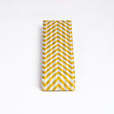 A Yuzen Washi Pen box, made in Japan from traditional chiyogami Japanese washi paper and featuring a herringbone patter in yellow, gray and white. Available at NiMi Projects UK.