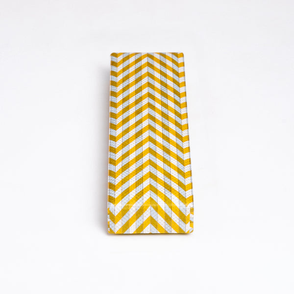 A Yuzen Washi Pen box, made in Japan from traditional chiyogami Japanese washi paper and featuring a herringbone patter in yellow, gray and white. Available at NiMi Projects UK.