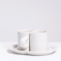 A NiMi Projects UK animation of a pair of Ceramic Japan white porcelain half-cups that sit together on a shared double saucer.