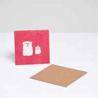 A red square Japanese Motif Mini Card, featuring an illustration of two white monkeys, with a brown envelope. Printed in Japan and available at NiMi Projects UK.