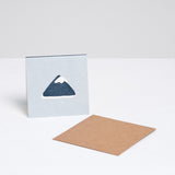 A pale blue square Japanese Motif Mini Card, featuring an illustration of a snow-capped Mount Fuji, with a brown envelope. Printed in Japan and available at NiMi Projects UK.