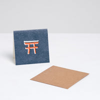 A navy blue square Japanese Motif Mini Card, featuring a picture of a red torii gate, with a brown envelope. Printed in Japan and available at NiMi Projects UK.