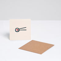 A square Japanese Motif Mini Card, featuring an illustration of a pair of chopsticks holding a norimaki sushi roll on a white background, with a brown envelope. Printed in Japan and available at NiMi Projects UK.