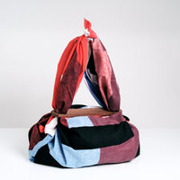 Masaru Suzuki's Horse Stripe Musubi furoshiki wrapping cloth made into a shoulder bag using two walnut wood Patchin clasp accessories, on show at NiMi Projects UK.