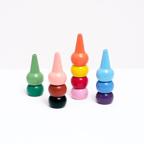 A set of 12 cone-shaped Aozora Baby Color japanese crayons, stacked into four columns of different colors, available at NiMi Projects UK.