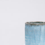 A closeup of an Asemi Iga-yaki Hydrangea Japanese tea cup, available at NiMi Projects,  showing details of the blue glaze on it's rim.