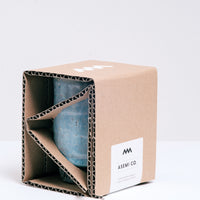 An Asemi Iga-yaki Hydrangea Japanese tea cup, displayed in its eco-friendly, corrugated card, folded open packaging, at NiMi Projects UK. 