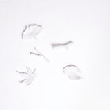 A set of five white porcelain chopstick rests in the shape of leaves and twigs, designed by Kaichiro Yamada for Ceramic Japan. Five shapes inspired by nature feature — a cherry-tree leaf, a ginkgo leaf and a maple leaf, plus two little branches.  All are made in Japan and available at NiMi Projects.