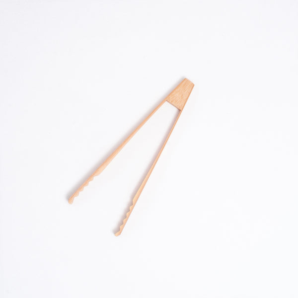A 18cm long pair of Japanese bamboo serving tongs with triangular top and ridged edges, ideal for serving salad and hor d'oeuvres, or used as ice tongs. Available at NiMi Projects UK.