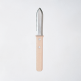 NiMi Projects UK's Japanese Asano Mokkousho Hori Hori gardening tool, with a stainless steel serrated-edged mini-trowel end  and a sustainable snow beech wood handle.