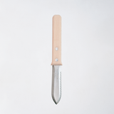 The Asano Mokkousho Japanese Hori Hori gardening tool, a mini trowel with a serrated edge for weeding and cutting, topped with a sustainable snow beech handle, available at NiMi Projects UK.