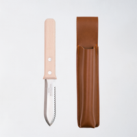 NiMi Projects UK's Asano Mokkousho Japanese Hori Hori gardening implement, with a sustainable snow beech handle and a serrated edge mini trowel end, on display next to a faux leather holder that can be attached to a belt.