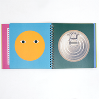 Two pages of NiMi Projects UK's Kokuyo Face Sticker Book, showing, on the left, a yellow circle with a pair of eyes, and, on the right, a top view of a tin can. The book features illustrations all by Japanese art unit Tupera Tupera.