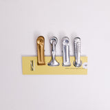 Four types of Nanmoku Japanese aluminium clips  — plain gold, butterfly, plain silver, modern - displayed as a set on a NiMi Projects UK card.