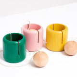 Three NiMi Projects Ototama Cup and Ball toys in green, baby pink and bright yellow. Each Ototama has a cup with a ball attached to its center, and is played like the Japanese game of kendama.