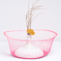 A pink Fukunaga latticed paper airvase, pulled into  shape around a Watanabe Thoki white vase, on disply at NiMi Projects UK
