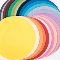 24 Fukunaga  paper airvases, each a different color, laid out on  display in their flat circular form, at NiMi  Projects UK.