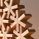 A closeup of Hositoshi, Japanese designer Sukima's star/asterisk-shaped wooden building blocks, available at NiMi Projects UK
